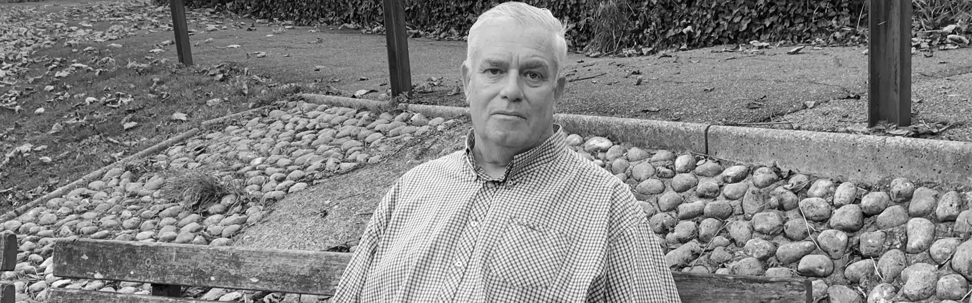 A man sitting on a bench in a park